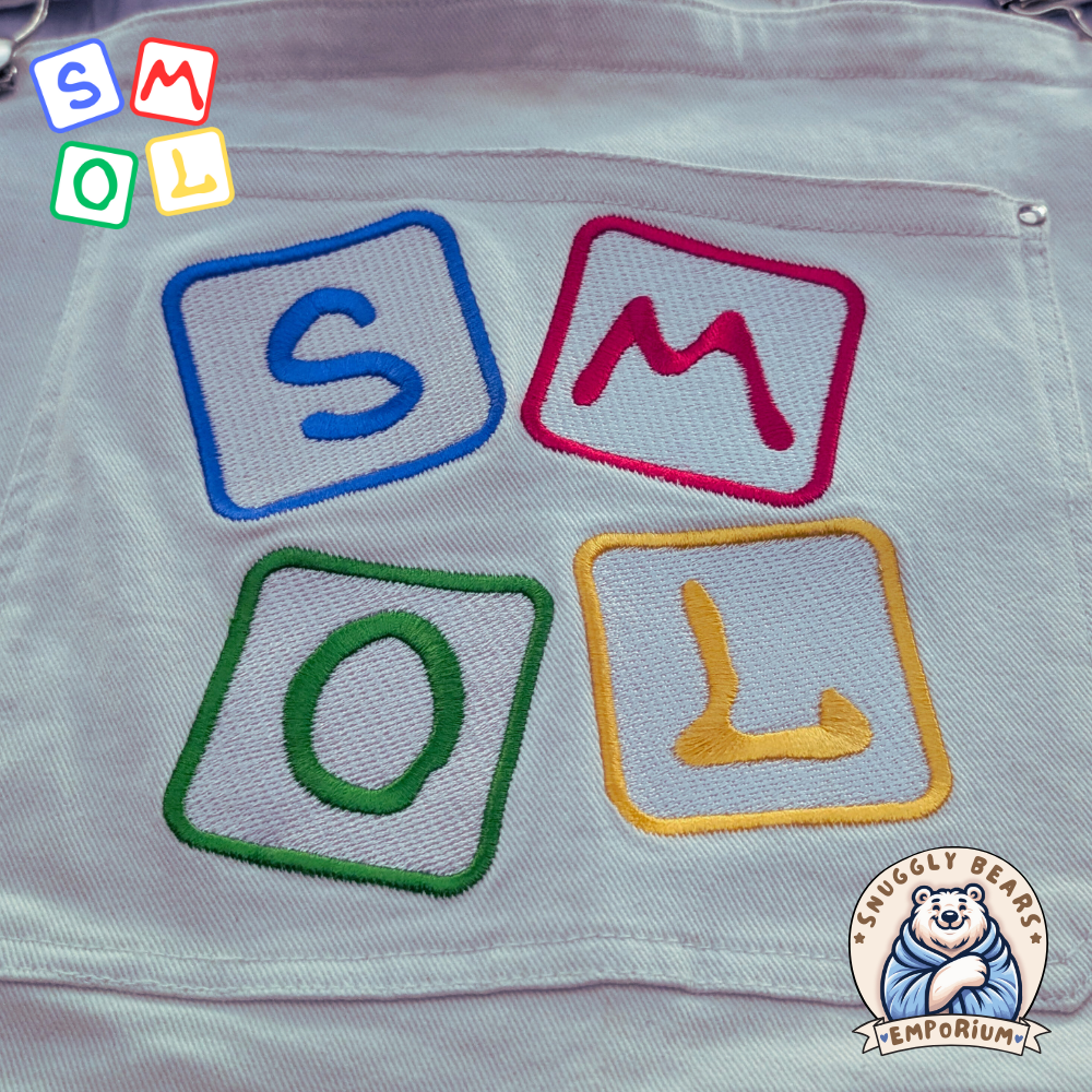 Person wearing SMOL shortalls and matching tee, showcasing a playful and cute style from Snuggly Bears Emporium.