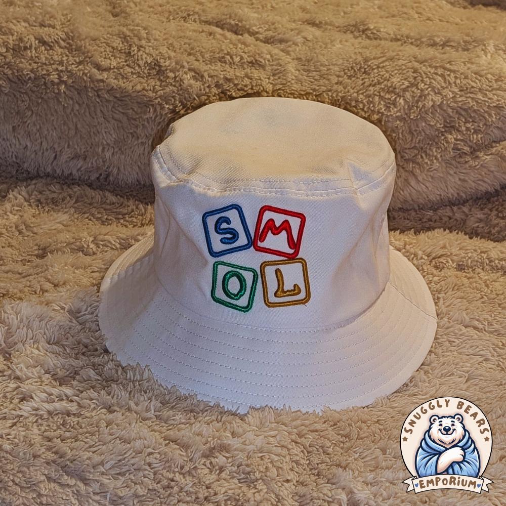 White SMOL bucket hat with colorful block letters, perfect for sunny outdoor playdates and stylish everyday wear.