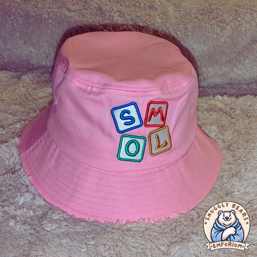 Pink SMOL bucket hat with colorful block letters, perfect for sunny outdoor playdates and stylish everyday wear.
