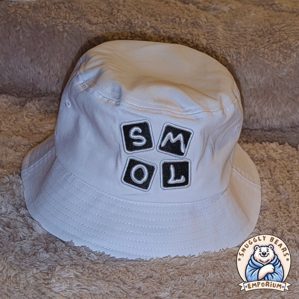 White SMOL bucket hat with black block letters, perfect for sunny outdoor playdates and stylish everyday wear.