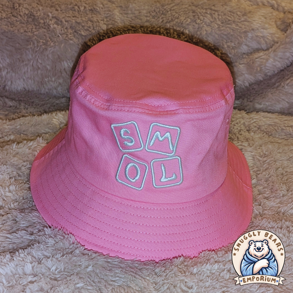 Pink SMOL bucket hat with white block letters, perfect for sunny outdoor playdates and stylish everyday wear.