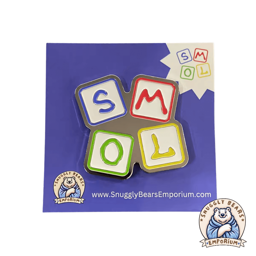 SMOL enamel pin badge featuring colorful alphabet blocks on a blue background.