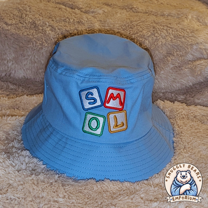 Blue SMOL bucket hat with colorful block letters, perfect for sunny outdoor playdates and stylish everyday wear.