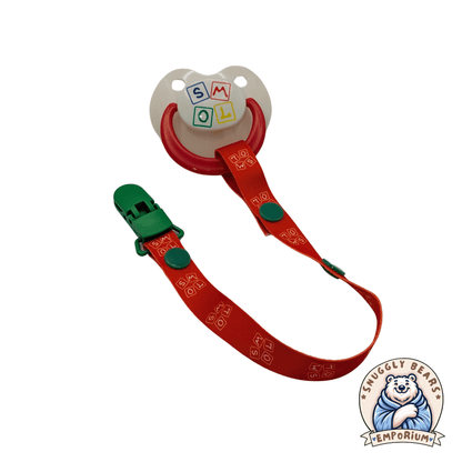 SMOL Pacifier and Clip in red with playful alphabet block logo, perfect for keeping binkies safe and stylish.